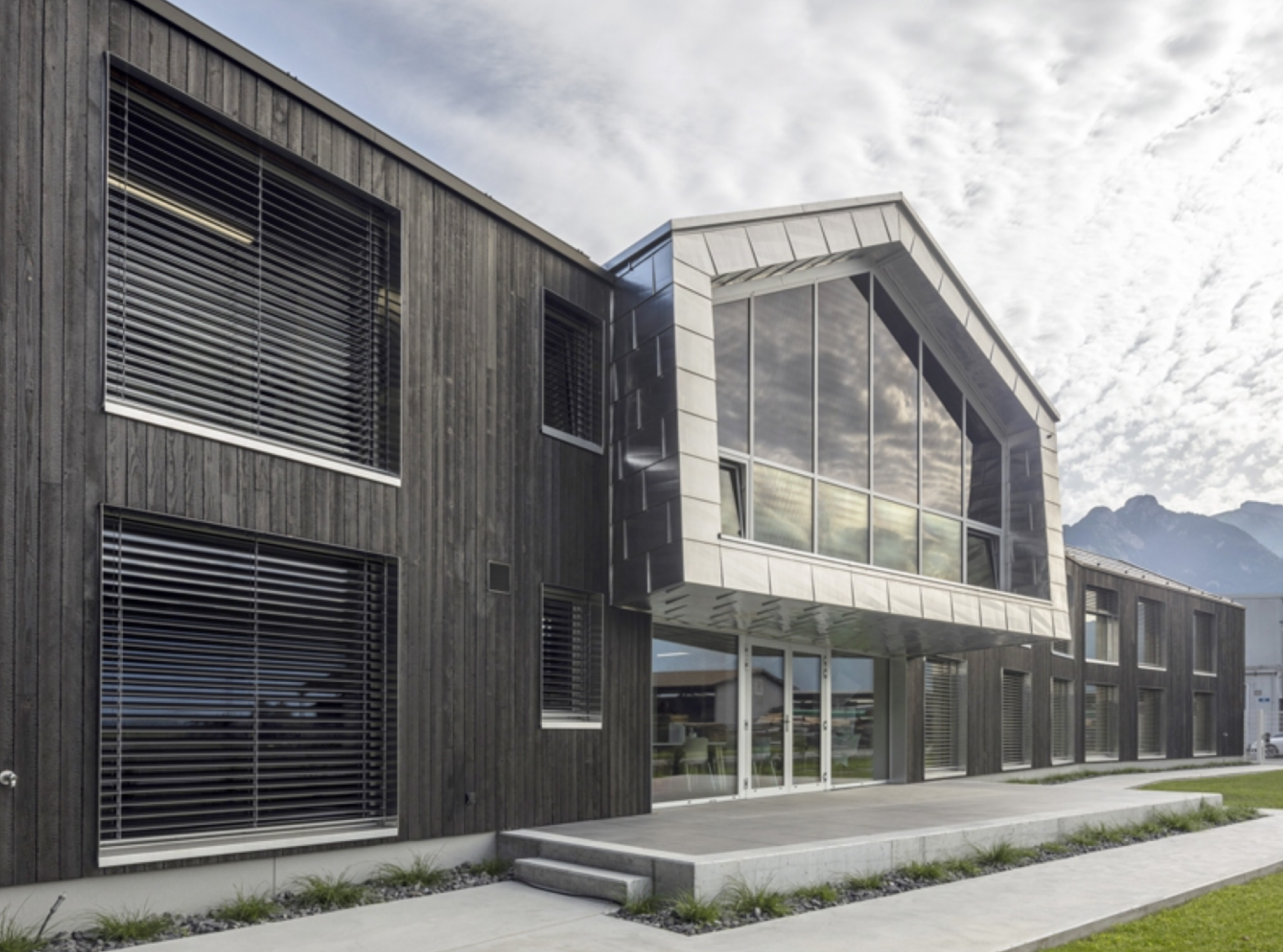 Modern building with large glass windows and wooden exterior