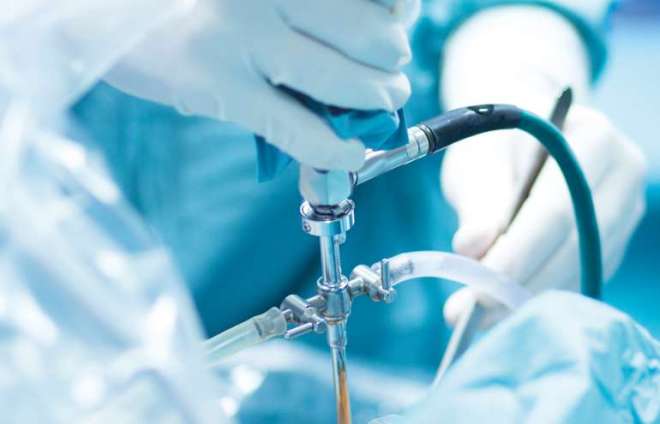 Surgeon using an arthroscopy tool during a medical procedure