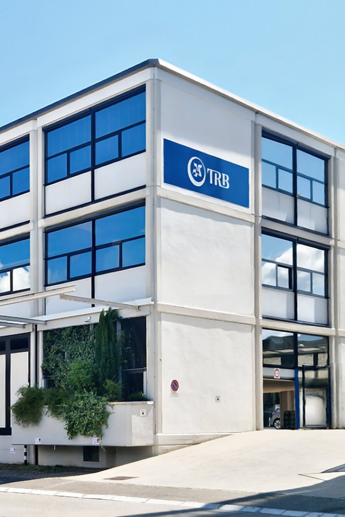 Exterior view of TRB building with large windows and greenery