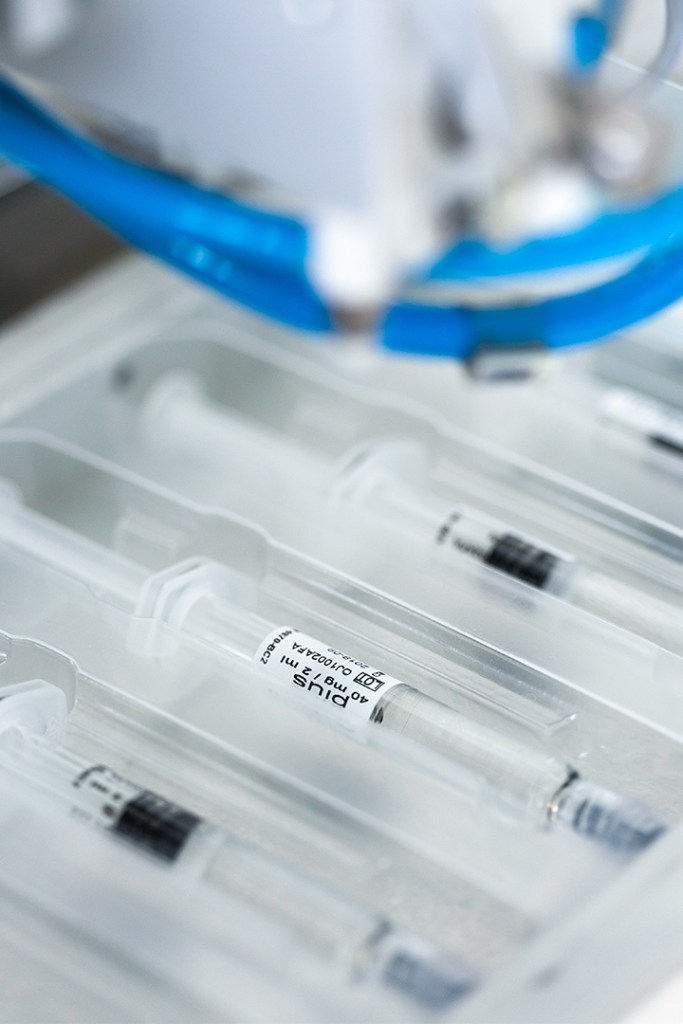 Syringes in a tray, labeled with dosage information