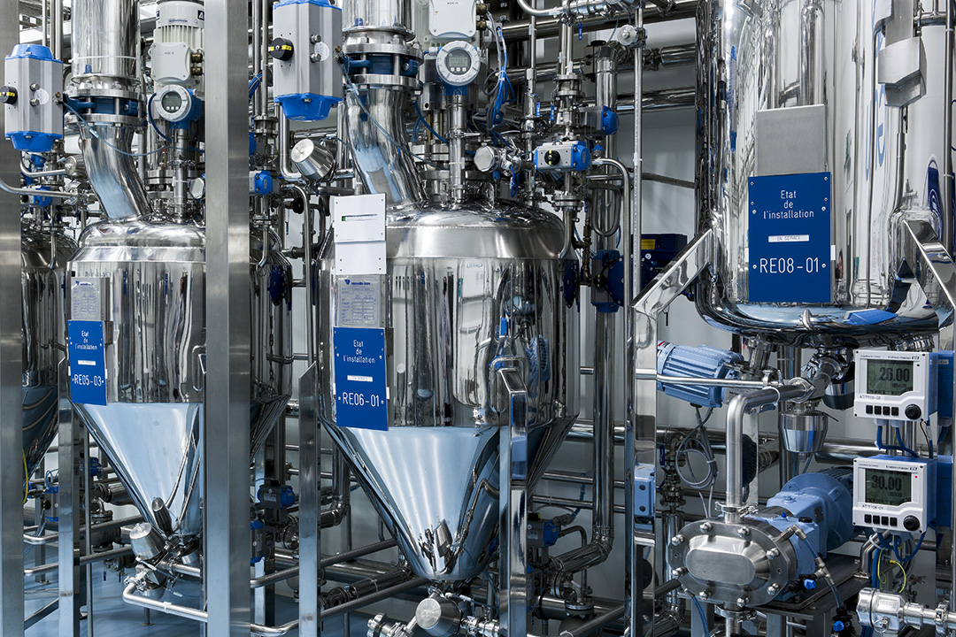 Industrial processing equipment with stainless steel tanks and control panels