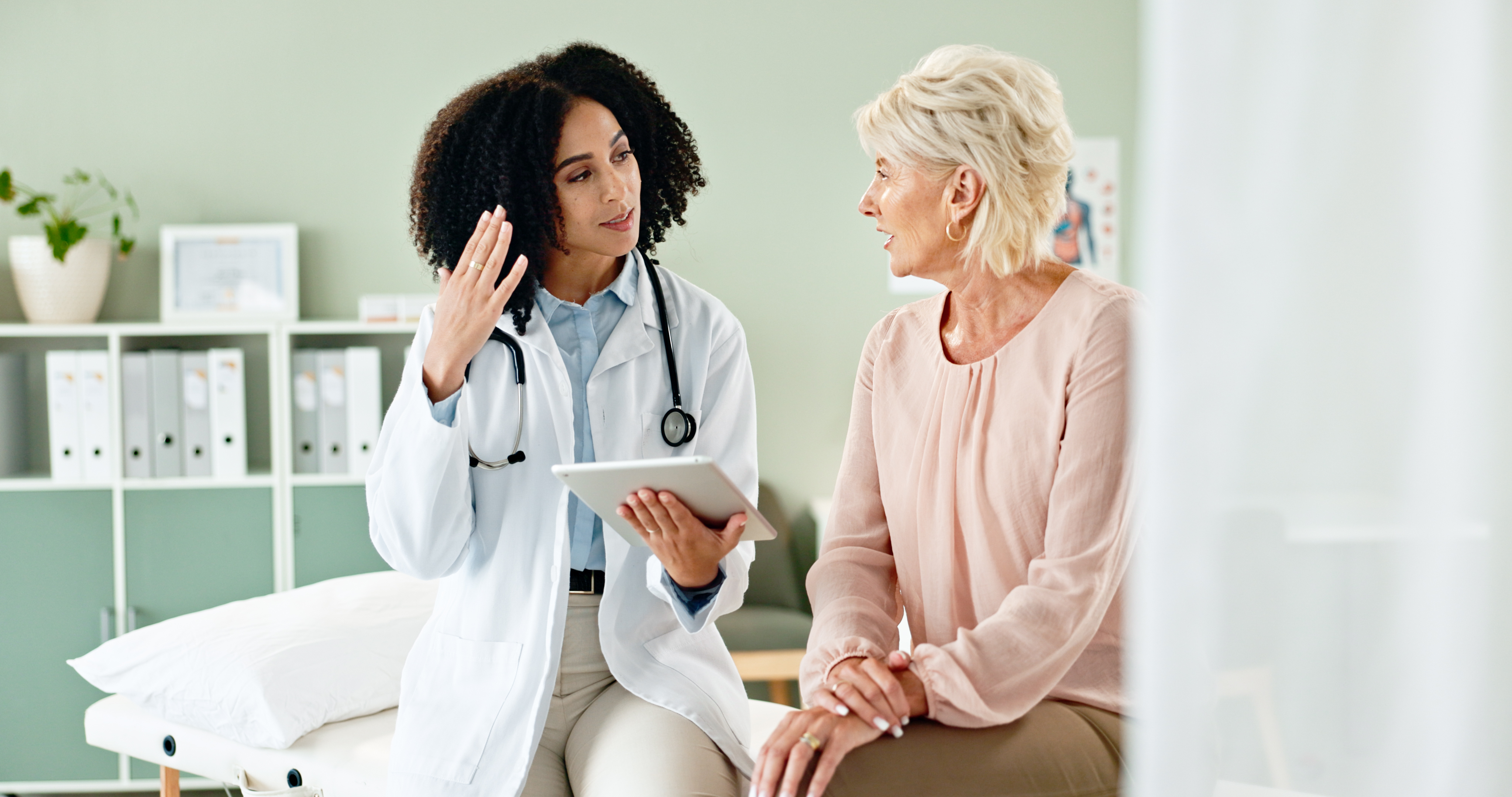 Woman, doctor and consulting with patient in checkup on tablet for medical results, diagnosis or prescription at hospital. Female person talking to client for consultation, help or advice at clinic